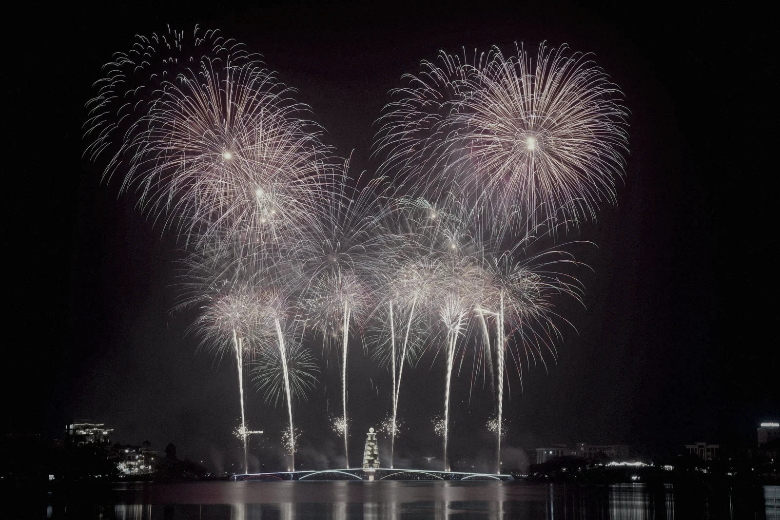Fireworks show over a lake at night